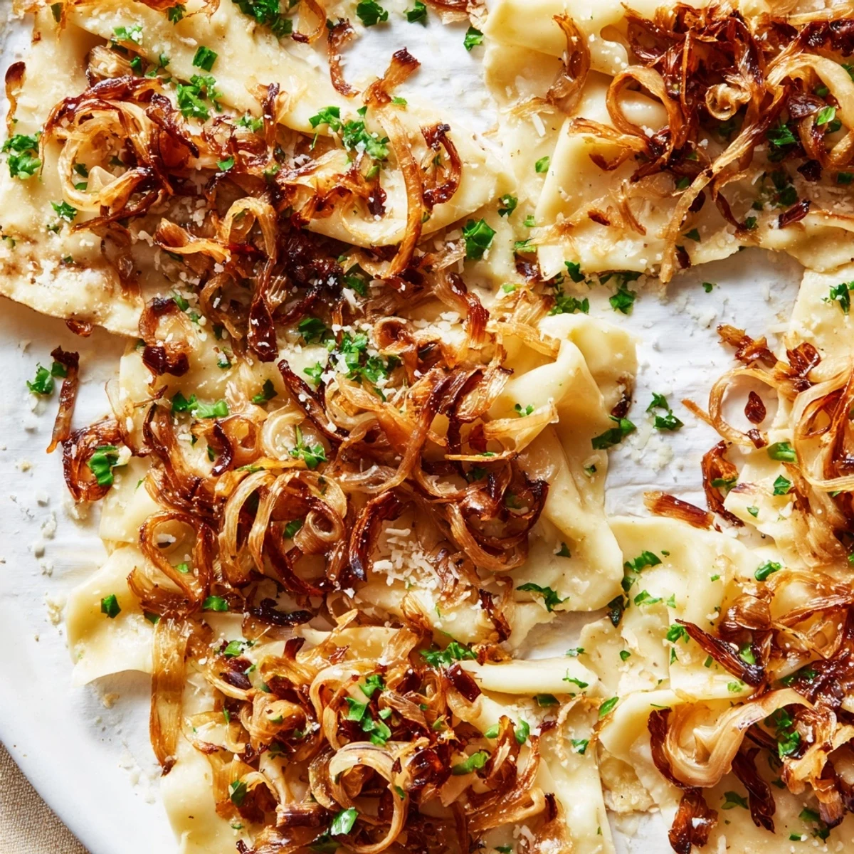 This baked German fusion, Savory Maultaschen Flatbread, has caramelized onions and fresh herbs for flavor.