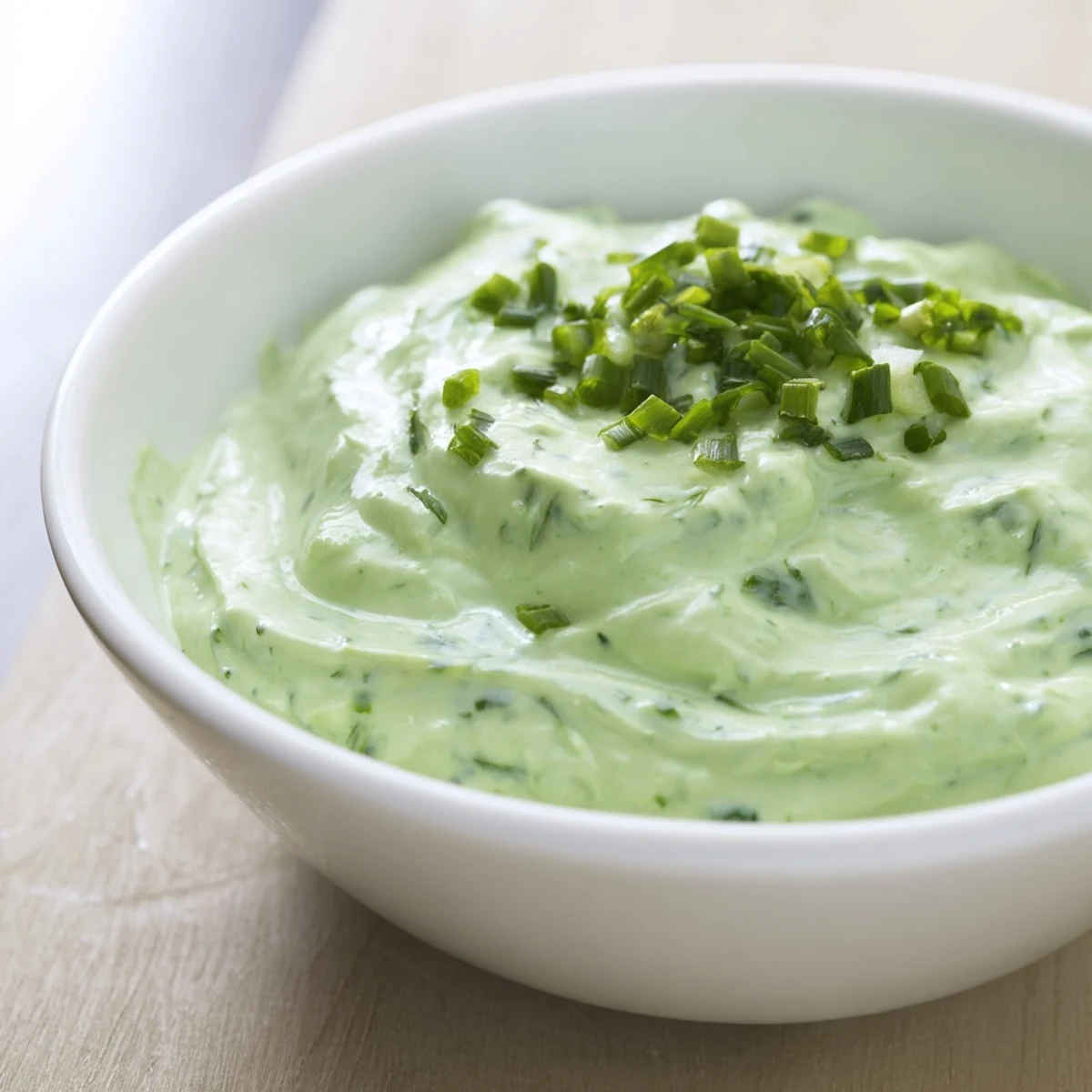 Creamy, bright green Green Goddess Dip, perfect spread, served with crisp, colorful vegetable sticks.